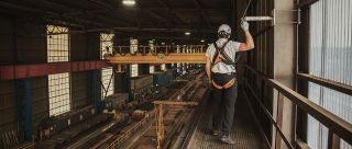 Linea vita con cavo SecuRope a soffitto in una fabbrica di acciaio